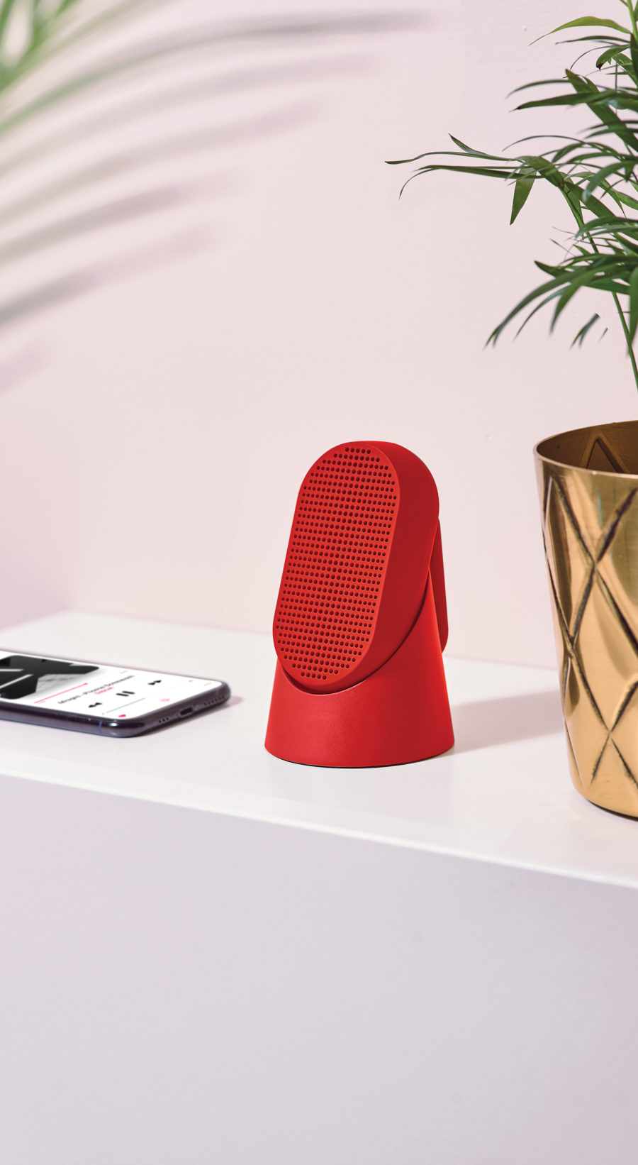 red outside bluetooth speaker on a table