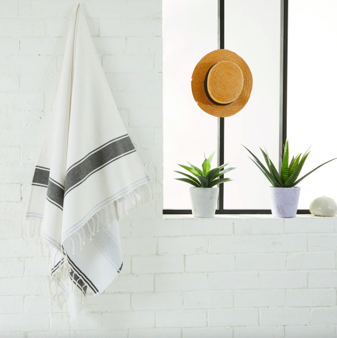 A white fouta on a bathroom wall