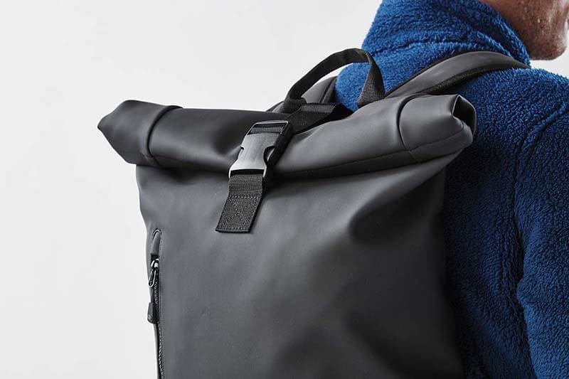 roll-top bagpack on a back of a man