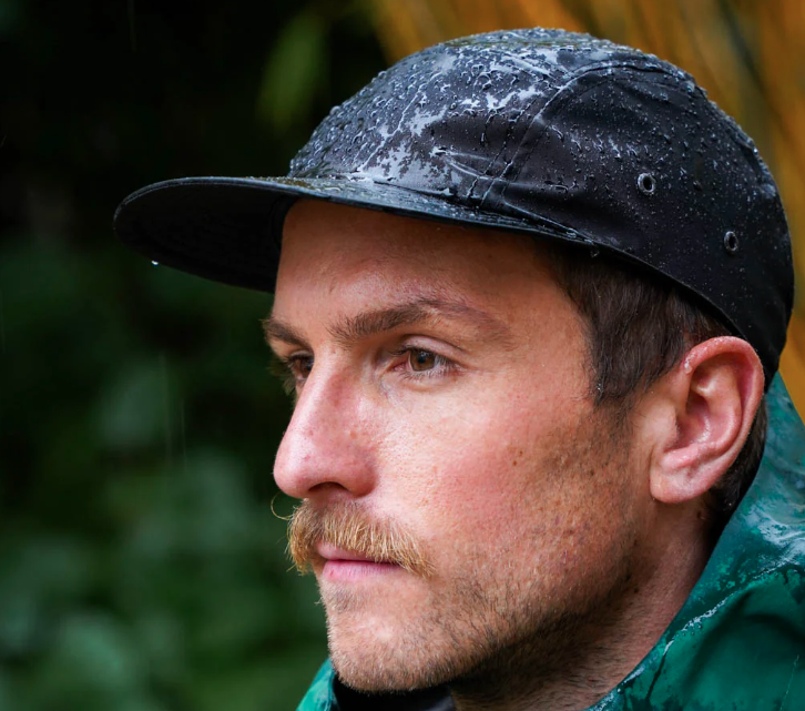 man wearing the black upcycled cap